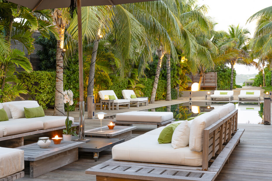 Villa K St. Barts pool deck lounge seating among palm trees