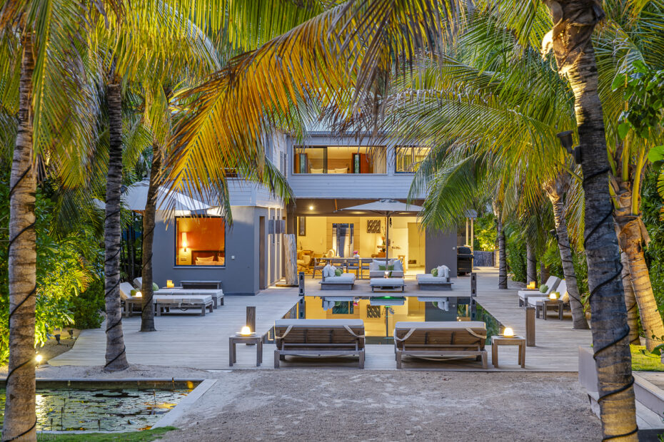 Villa K St. Barts at dusk with pool terrace and palm trees